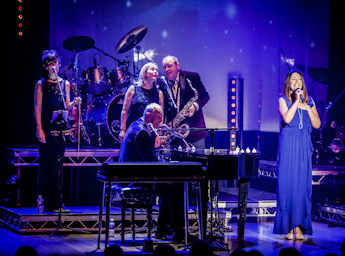 A picture of the Carpenters Story band performing on stage.