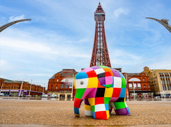 A picture of a sculpture of Elmer in front of the tower.